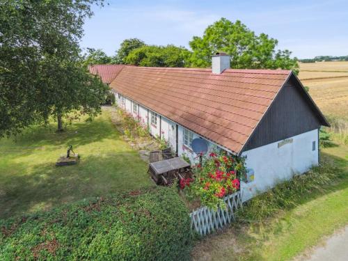 an overhead view of a barn with flowers in front of it at Holiday Home Héléne - 2-4km from the sea by Interhome in Åkirkeby