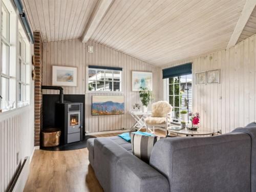 a living room with a couch and a fireplace at Holiday Home Diddi - 170m from the sea by Interhome in Frørup