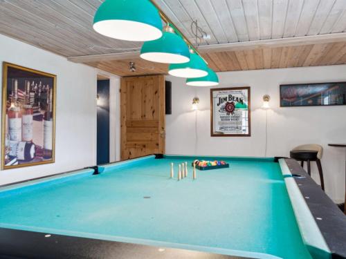 a pool table in a gaming room with lights at Holiday Home Ieva - 3-9km from the sea by Interhome in Åkirkeby
