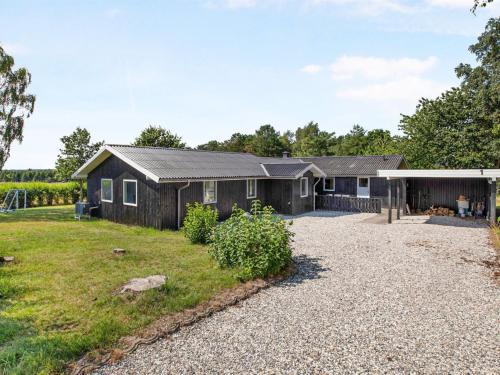 a house with a gravel driveway at Holiday Home Neele - 800m from the sea by Interhome in Glesborg