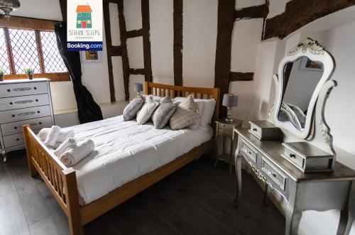 a bedroom with a bed with a dresser and a mirror at Spacious 5 Family Rooms House By Shropshire Escapes Short Lets & Serviced Accommodation Shrewsbury With Free WiFi in Shrewsbury