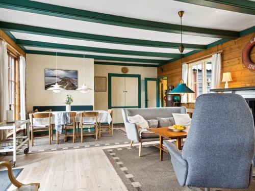 a living room with a couch and a table at Holiday Home Antonina - 10m from the sea by Interhome in Martofte