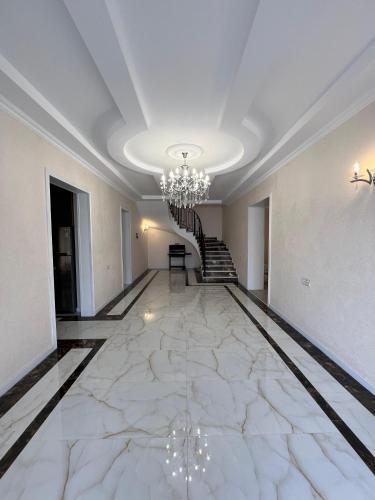 a room with a marble floor with a chandelier at Red Brick House in Şürük