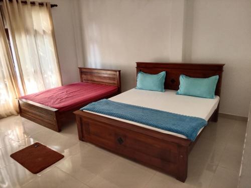 Postel nebo postele na pokoji v ubytování Bosadi holiday home katunayaka