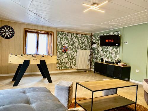 a living room with a ping pong table in it at Le refuge Alsace au pied des Vosges animaux ok in Urbès