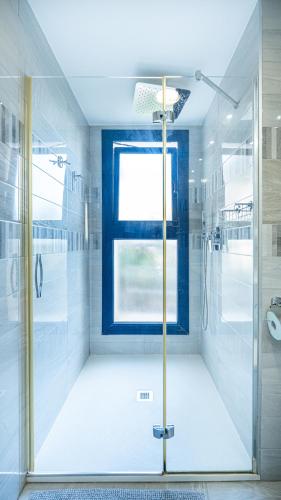 a bathroom with a shower and a window at Perfect Ground Floor with Sea View in Punta Prima