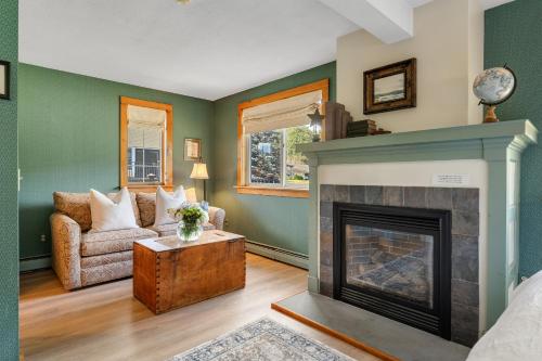 a living room with a fireplace and a couch at Red Clover Inn in Mendon