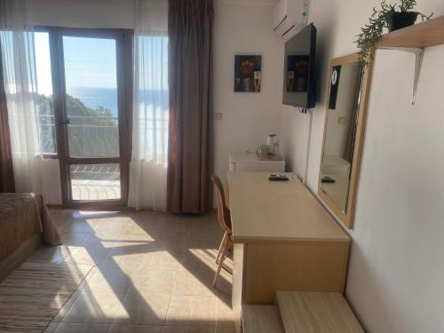 a room with a bathroom with a vanity and a mirror at Only Adults- RAI in Golden Sands