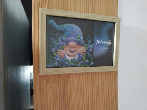 a picture of a person with flowers on a wall at La Ferme Du Levant in Gérardmer