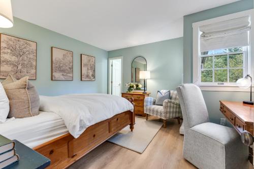a bedroom with a bed and a desk and a chair at Red Clover Inn in Mendon