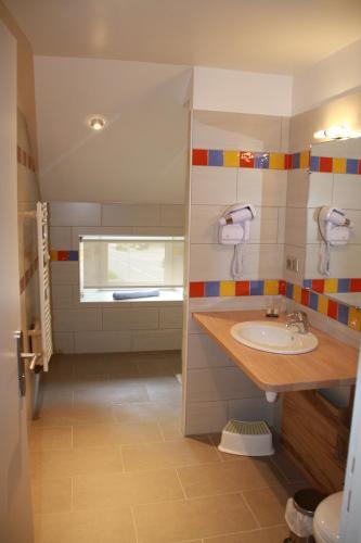 a bathroom with a sink and a window at La petite auberge de niaux in Niaux