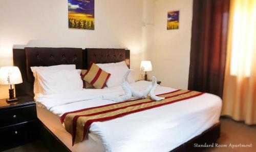 Postel nebo postele na pokoji v ubytování BT Hotel Aparatment