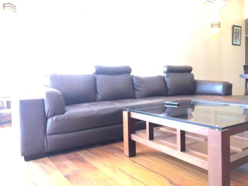 a living room with a couch and a coffee table at Enkombe Place in Kampala
