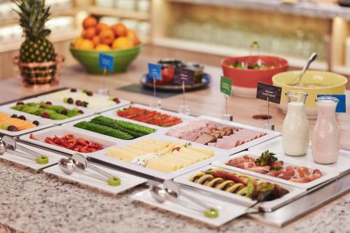 a buffet with different types of food on a table at Hampton by Hilton Gdansk Airport in Gdańsk-Rębiechowo