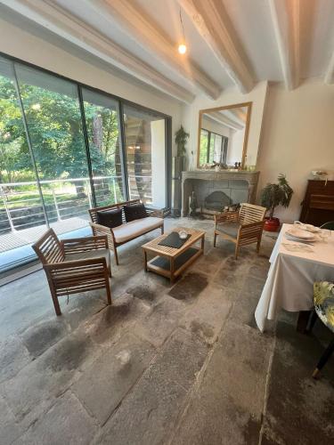 a living room filled with furniture and a fireplace at Chambres de hôte les moulin la paille in Veyre-Monton