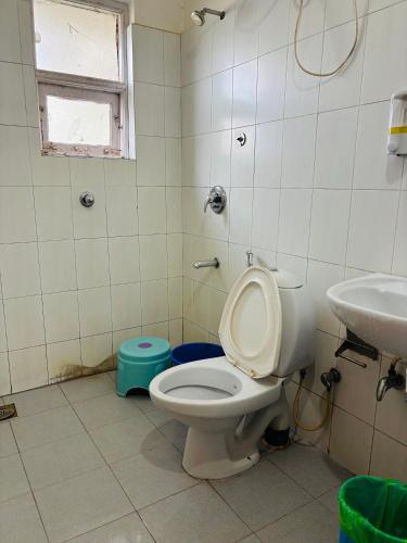 a bathroom with a toilet and a sink at M R Holidays Apartments in Arpora