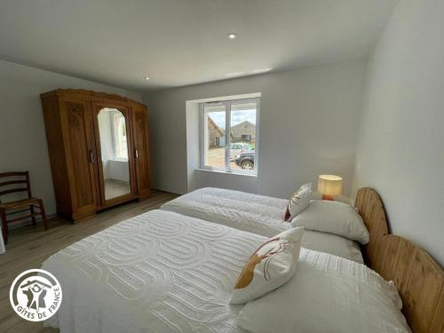 a bedroom with a large bed and a window at Gîte La Féneraie in La Roche-sur-Yon