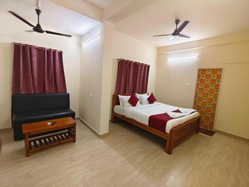 a bedroom with a bed and a chair and a window at Skyry Residency in Chennai