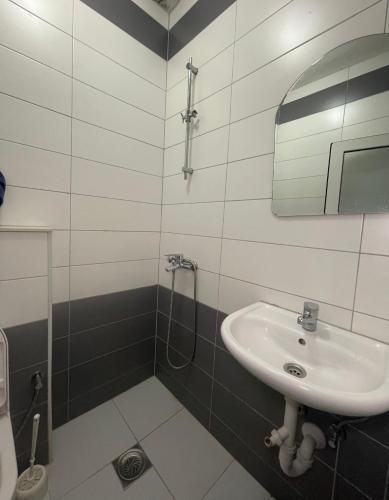 a bathroom with a sink and a shower at Restaurant Piknik in Prizren