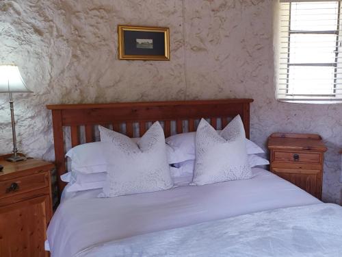 a bedroom with a white bed with white pillows at Haggards on Hilldrop in Newcastle