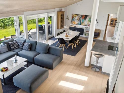 a living room with a blue couch and a table at Holiday Home Tuulikki - 100m from the sea by Interhome in Nyrup