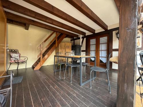a dining room with a table and chairs at Relais du Dompeter in Molsheim