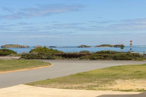 an empty road with a view of the ocean at The Coastal Retreat Two-unit Oasis in Shoalwater