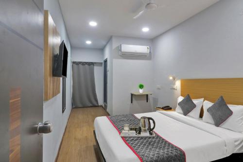 a hotel room with a bed and a sink at Townhouse S Continental in Hyderabad