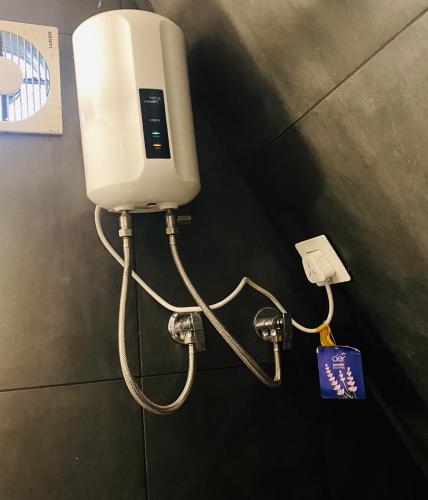 a soap dispenser on a wall in a bathroom at Royal Woods in Meppādi