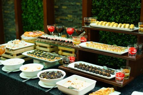 a table topped with lots of different types of food at Nine Tree Luxury Hotel & Suites Lahore in Lahore