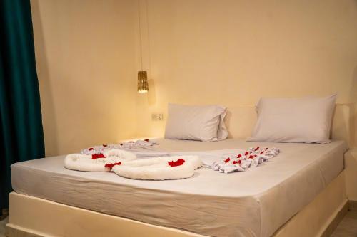 a bed with towels and flowers on it at Hostel 197 in Nungwi