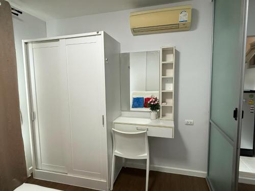 a small room with a white desk and a chair at Spacious 1 Bedroom, with sofa bed and Balcony in Kathu
