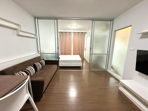 a living room with a couch and a bed at Spacious 1 Bedroom, with sofa bed and Balcony in Kathu