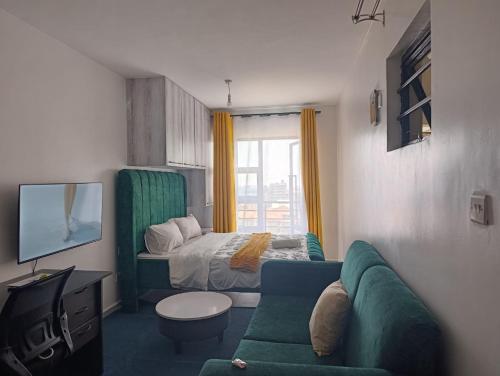 a small living room with a bed and a couch at Luxe Studio Kinoo in Rungiri