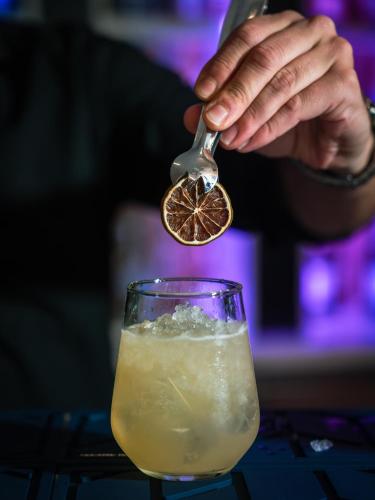 a person is stirring a drink with a spoon at YOTEL Porto in Porto