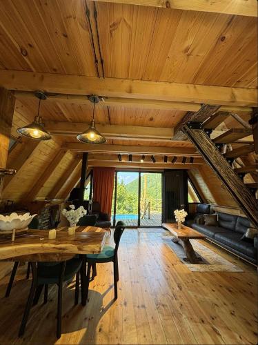 a large living room with a table and a couch at MOSES HOUSE-მოსეს სახლი in Baladzeyebi