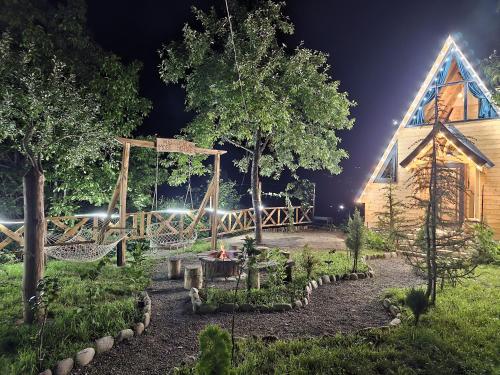 a garden in front of a church at night at MOSES HOUSE-მოსეს სახლი in Baladzeyebi