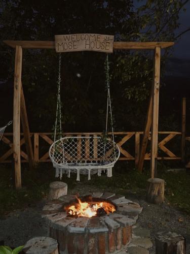 a fire pit with a sign that reads welcome to a house at MOSES HOUSE-მოსეს სახლი in Baladzeyebi