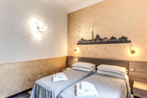 two beds in a room with towels on them at Hotel Centro Cavour Roma in Rome