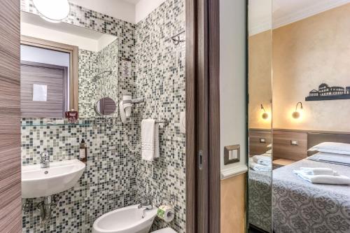 a bathroom with a sink and a mirror at Hotel Centro Cavour Roma in Rome