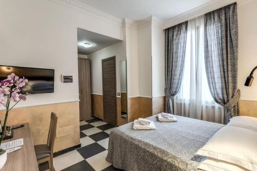 a hotel room with a bed and a table at Hotel Centro Cavour Roma in Rome