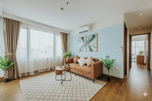 a living room with a couch and a table at Crescendo Limitless Style in Hanoi