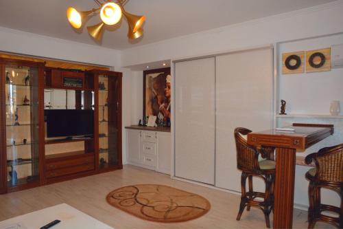 a living room with a desk and a table and chairs at Boutique Citadel in Eforie Nord
