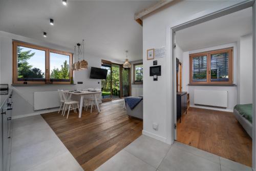 a living room with a kitchen and a dining room at Green Deer Premium in Zakopane