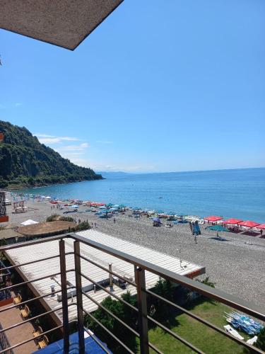 a view of a beach with umbrellas and the ocean at Hotel Lazuri in Kvariati