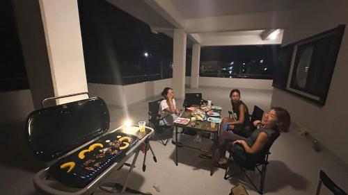 a group of people sitting at a table in a room at -The Kabira- The closest private villa to Kabira Bay! Free car rental & BBQ in Ishigaki Island