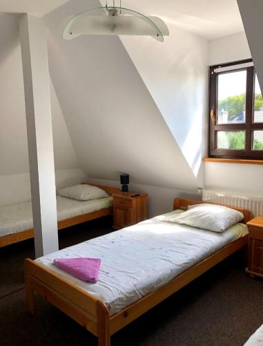 a bedroom with two beds and a window at Noclegi Hrubieszów in Hrubieszów