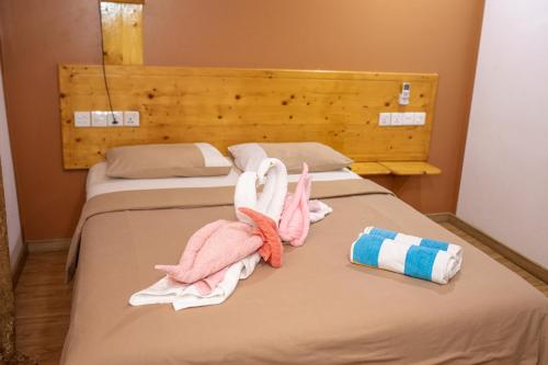 two towels on a bed in a room at Ever Blue Guest House in Mathiveri