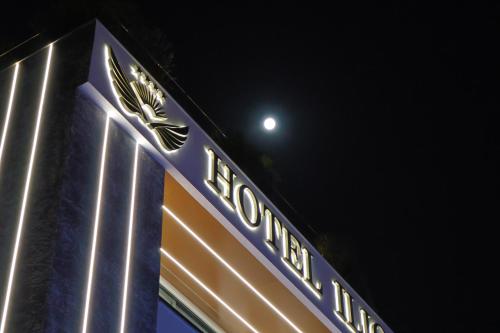 a sign for a hotel with the moon in the background at Ilio Boutique Hotel in Ksamil