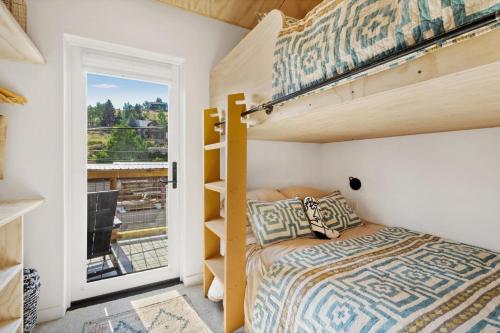 a bedroom with a bunk bed and a window at OMI Combo in Creede, CO in Creede